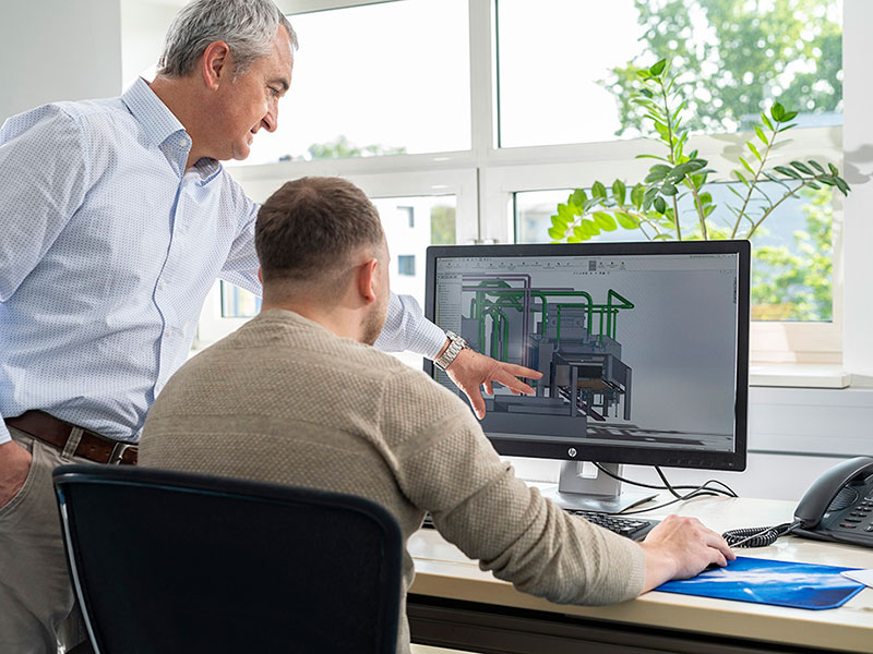 Two engineers discussing a CAD drawing